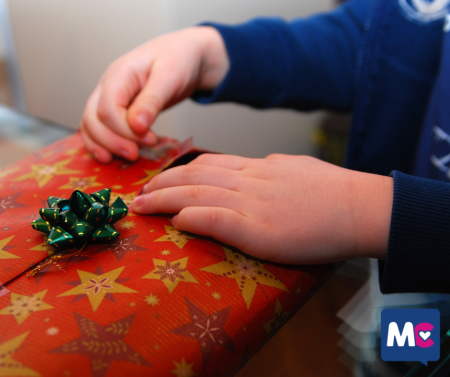 Child Opening Gift Secret Santa